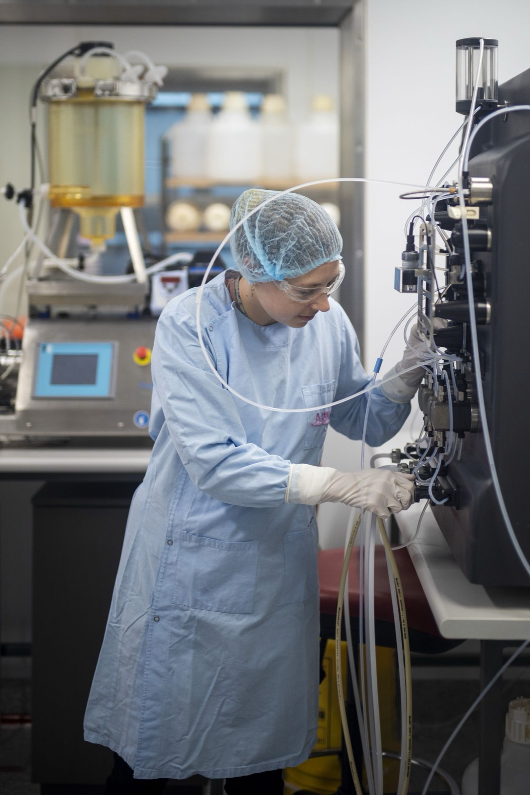 NBF scientist operating a chromatography purification system in the bioprocessing lab